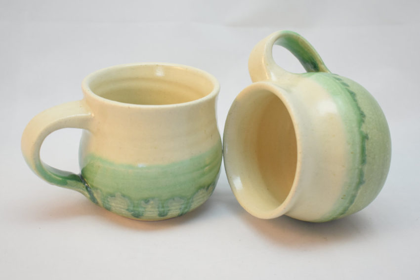 round green and white stoneware mugs